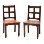 A pair of oak hall chairs,