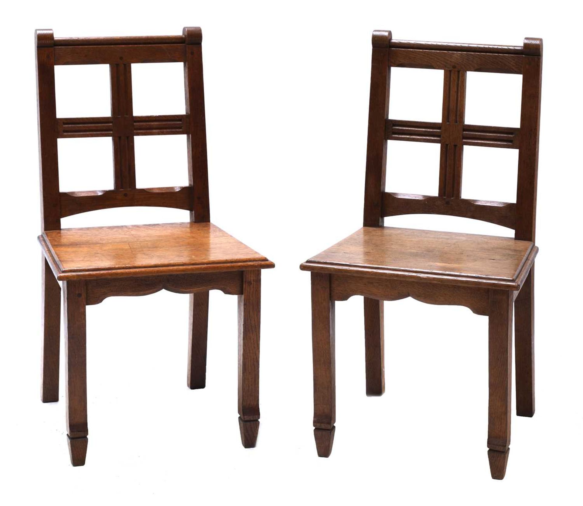 A pair of oak hall chairs,