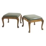 A pair of walnut stools,