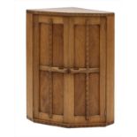 An oak hanging corner cupboard,