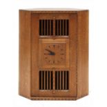 An oak hanging corner cupboard,