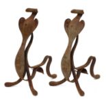 A pair of Arts and Crafts wrought iron fire dogs,