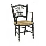 A Morris & Co. ebonised elbow chair,