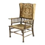 An Arts and Crafts oak wingback armchair,