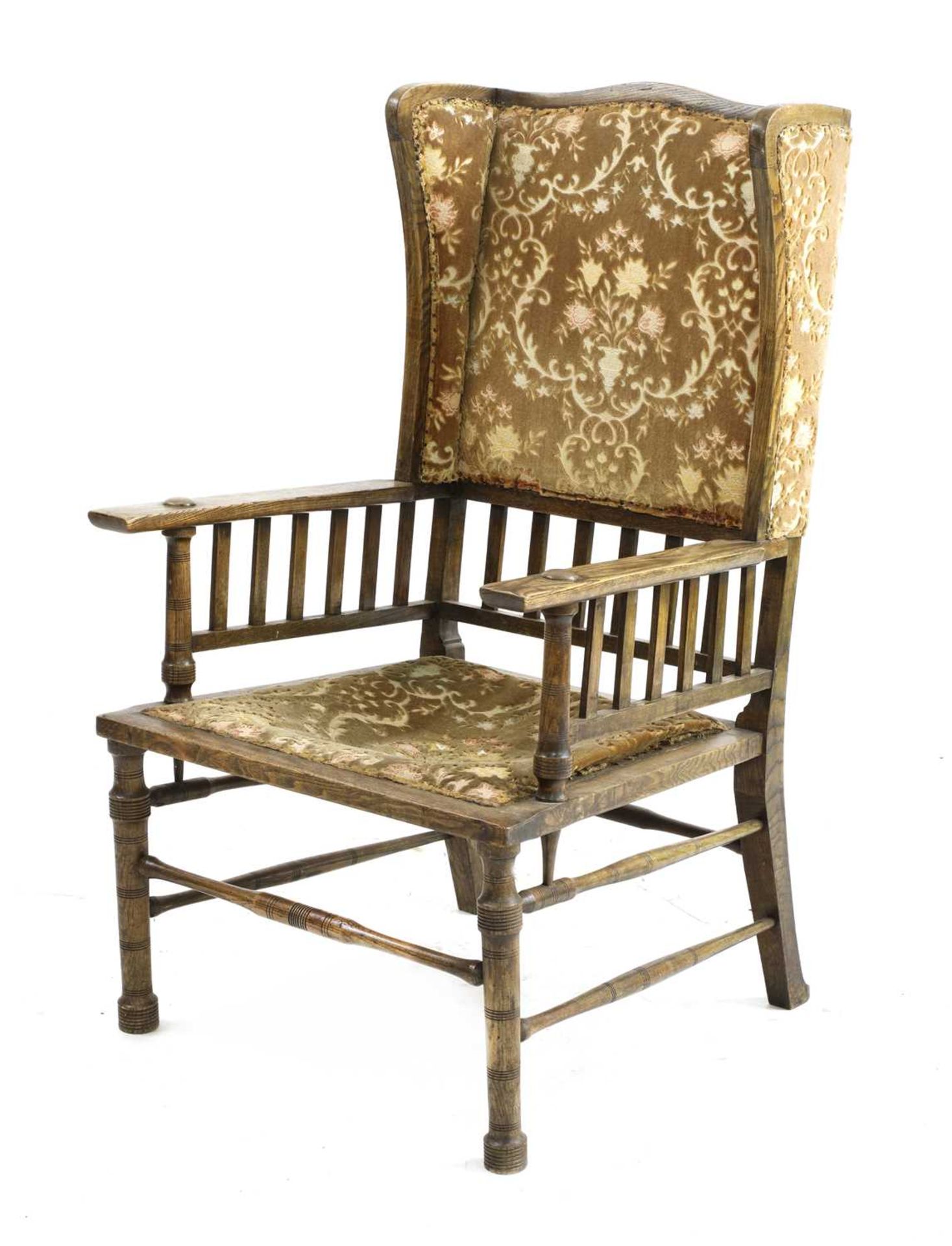 An Arts and Crafts oak wingback armchair,