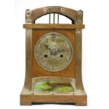 A Secessionist oak and brass-mounted mantel clock,