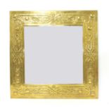 An Arts and Crafts embossed brass mirror,