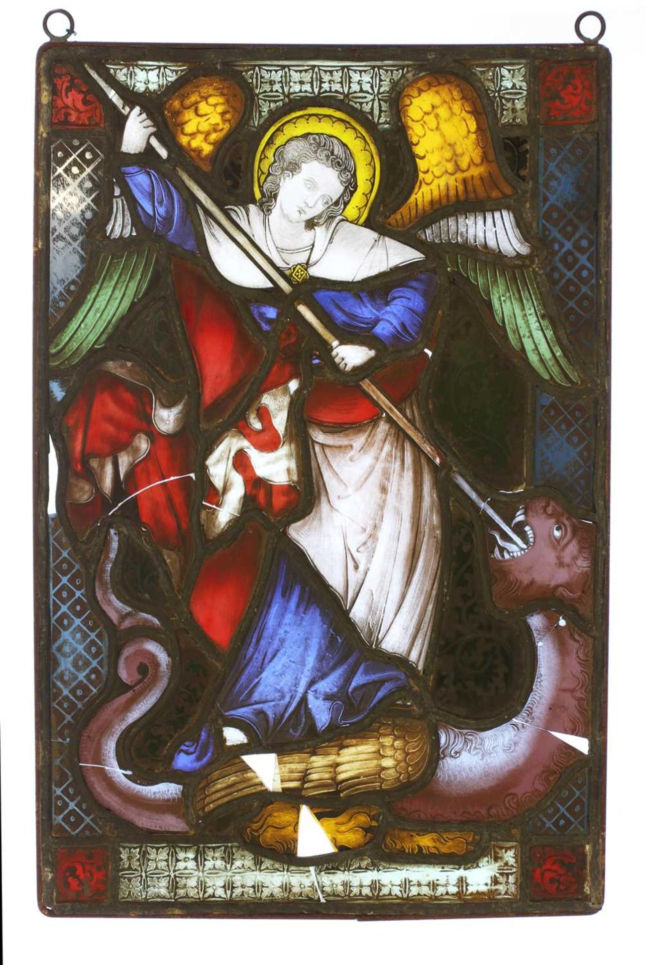 A stained glass panel of an angel lancing a dragon,