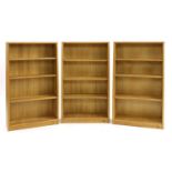 A set of three oak open bookcases,