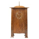 A rare Arts and Crafts oak architectural clock, designed by CFA Voysey, c. 1902,