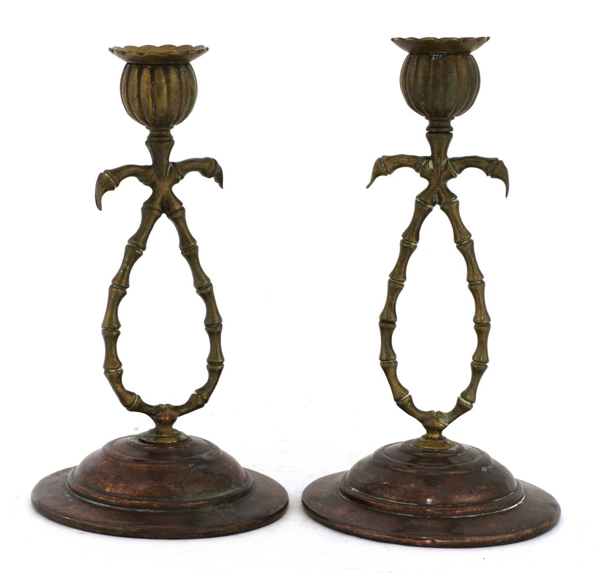 A pair of brass and copper candlesticks,