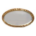 An Arts and Crafts oval copper mirror,