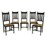 A set of five Arts and Crafts oak and ebonised chairs,