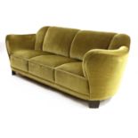 A Danish green velour three-seater settee,