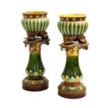 A pair of Doulton Lambeth stoneware jardinières on stands,