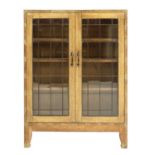 An Arts and Crafts oak glazed bookcase,