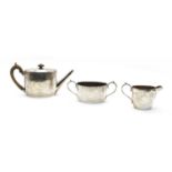 A composed silver three piece tea service,