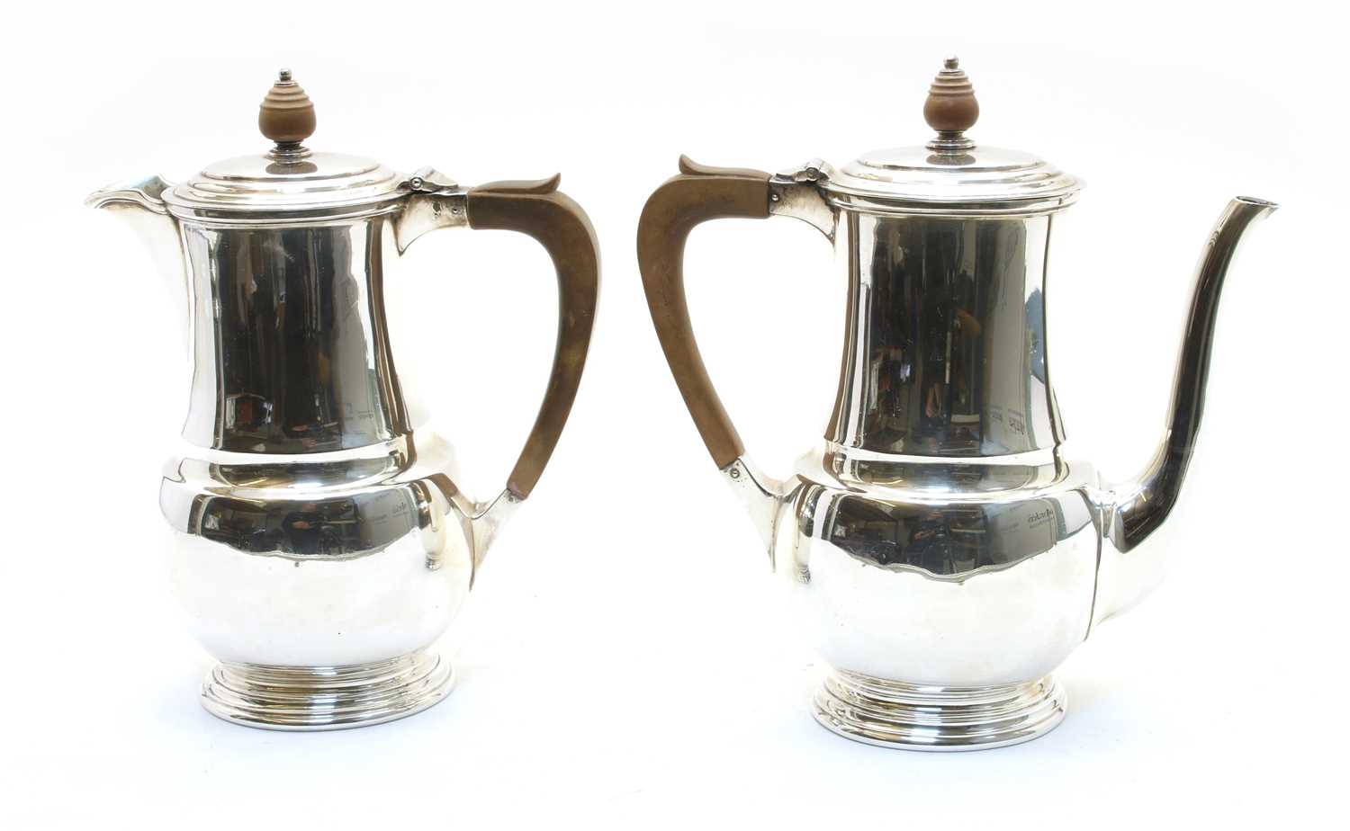 A silver coffee pot and water pot,