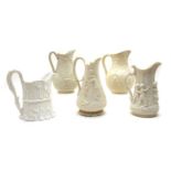 A collection of five Victorian relief-moulded white stoneware jugs