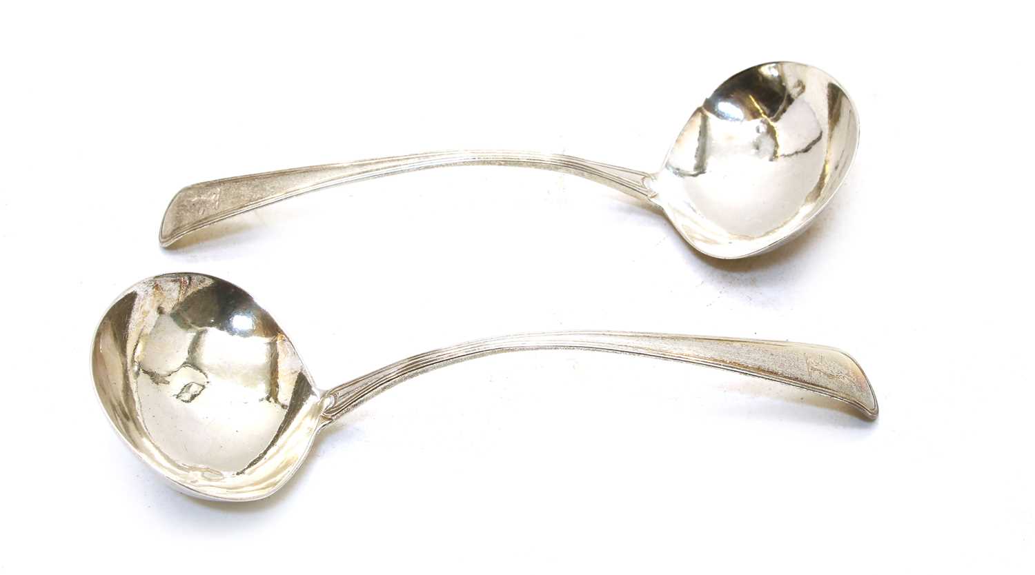 A pair of George III Old English pattern and thread silver sauce ladles,