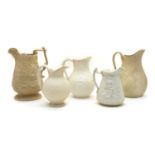 Five Victorian white stoneware relief-moulded jugs,