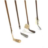 A mixed collection of four vintage hickory shafted golf clubs,
