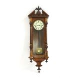A late 19th century Austrian walnut cased wall clock,
