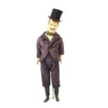 A late 19th papier-mache figure of a gentleman on stand,