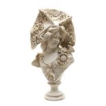 A resin moulded bust of a lady wearing an elaborate hat,