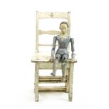 A 20th century blue and white seated plaster figure,