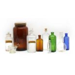 A collection of glass chemist's bottles and jars, etc.