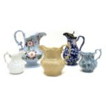 Eleven various pottery jugs,