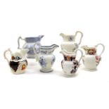 A collection of thirteen various pottery jugs,