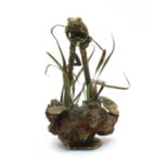 A mid 20th century San-Francisco bronze sculpture of a frog perched on two bamboo poles,