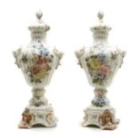 A pair of Italian Faience pottery cover vases on stands,