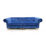 A contemporary blue velvet upholstered button back Chesterfield sofa
