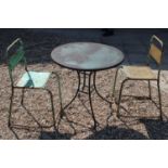 A circular garden table and two chairs,