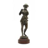 A bronze of a boy shepherd playing a pipe,