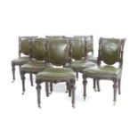 A set of seven Victorian green leather upholstered dining chairs,