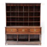 A George III oak dresser with open pot board base and rack,