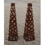 A pair of pierced metal obelisks,