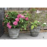 A pair of composite stone garden urns,