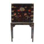 A Chinese black lacquered and gilt metal mounted cabinet on stand