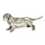 A cast silver figure of a dachshund,