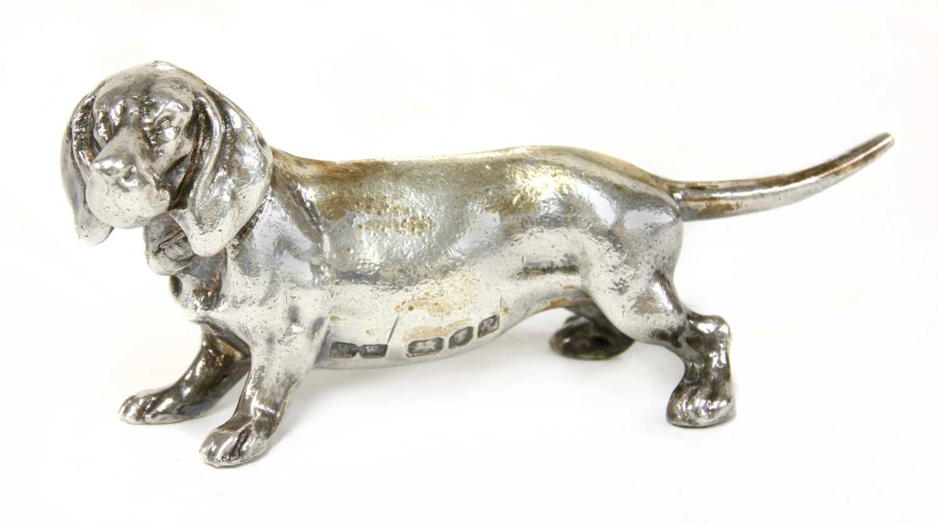 A cast silver figure of a dachshund,