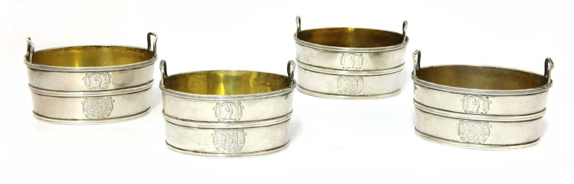 A set of four twin-handled George III silver salts,