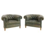 A pair of Victorian green leather button upholstered club armchairs,