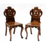 A pair of Victorian oak hall chairs,