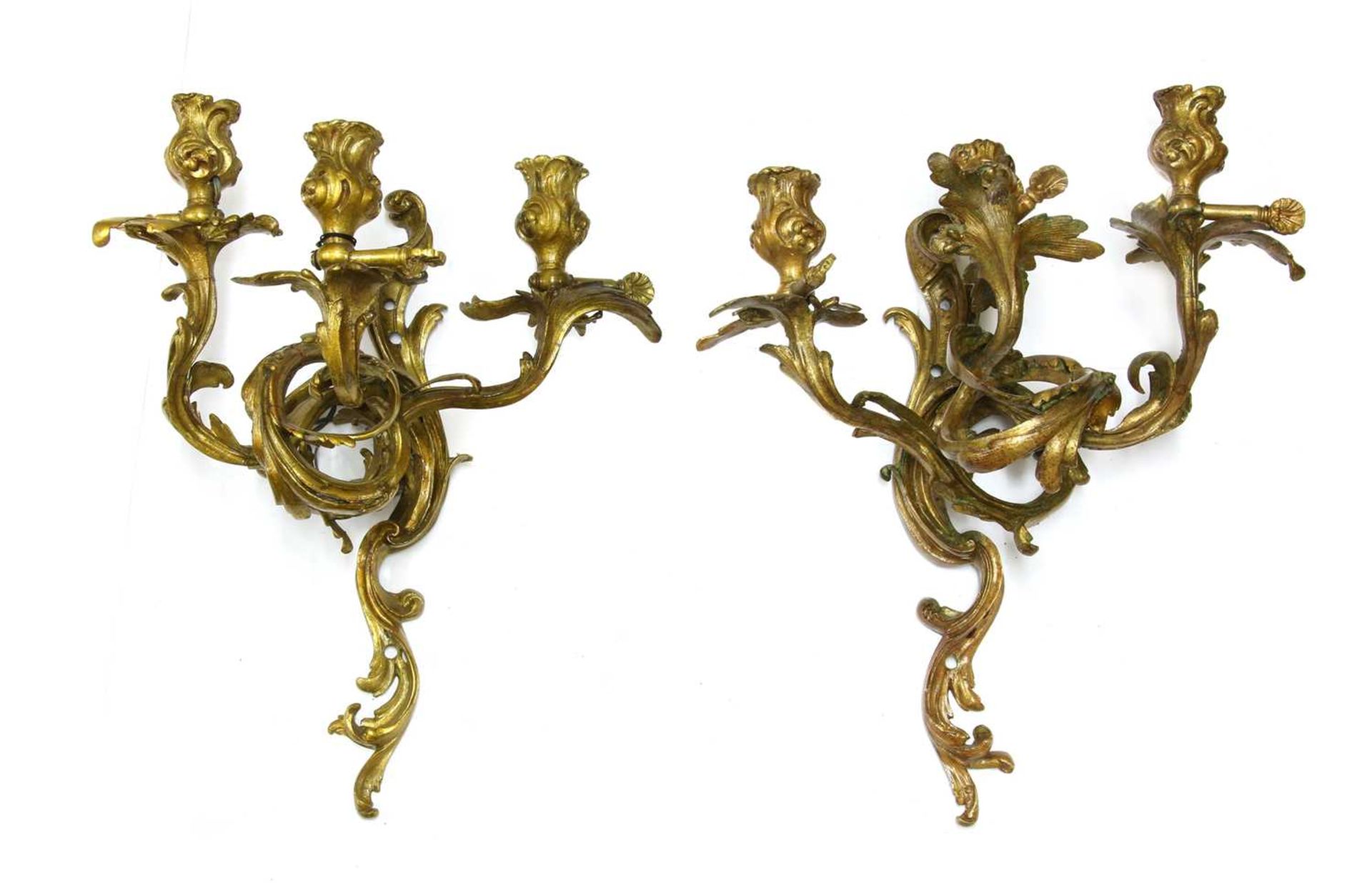 A pair of Louis XV-style bronze three-branch wall lights,