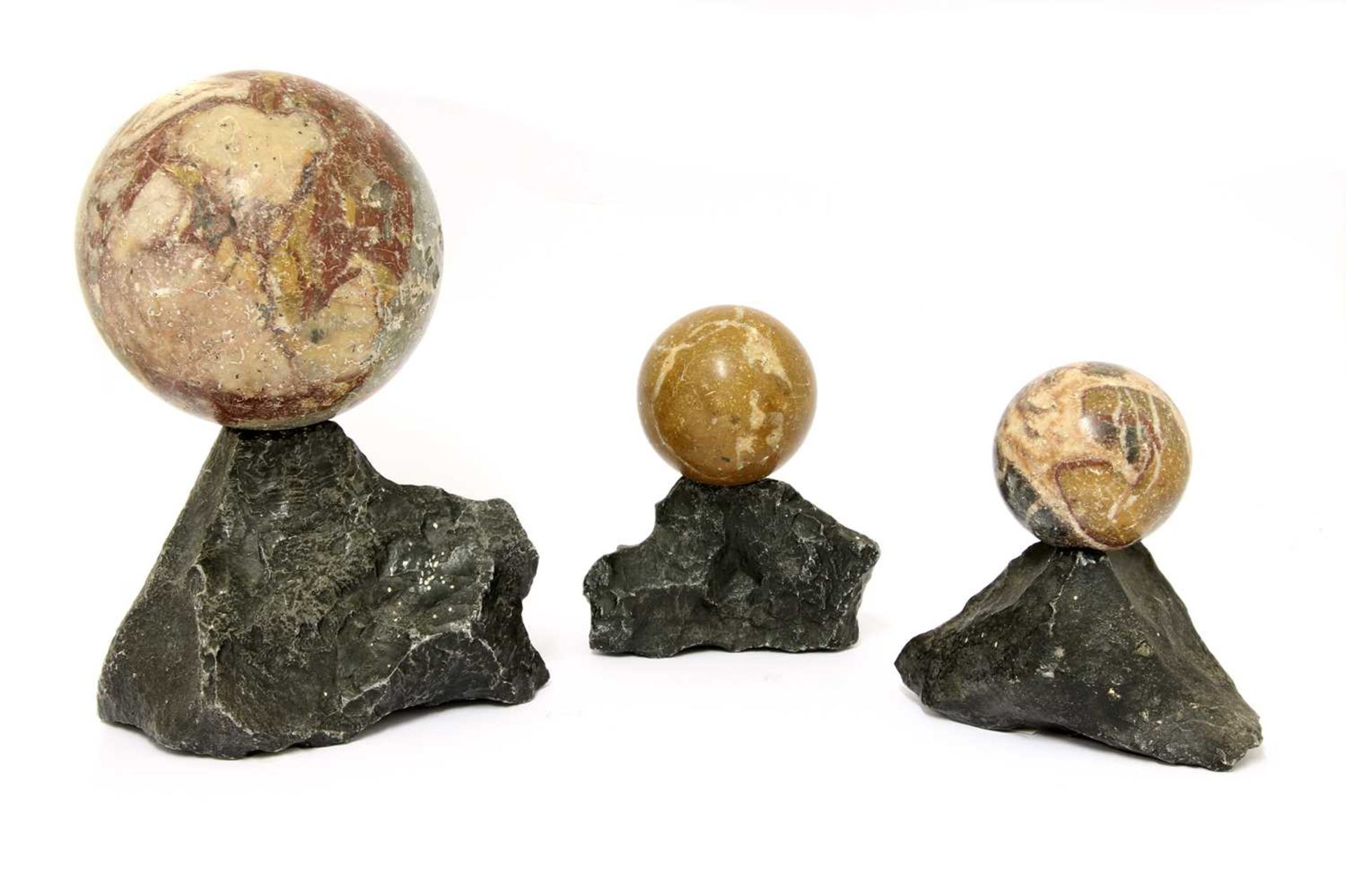 A trio of grand tour marble balls,